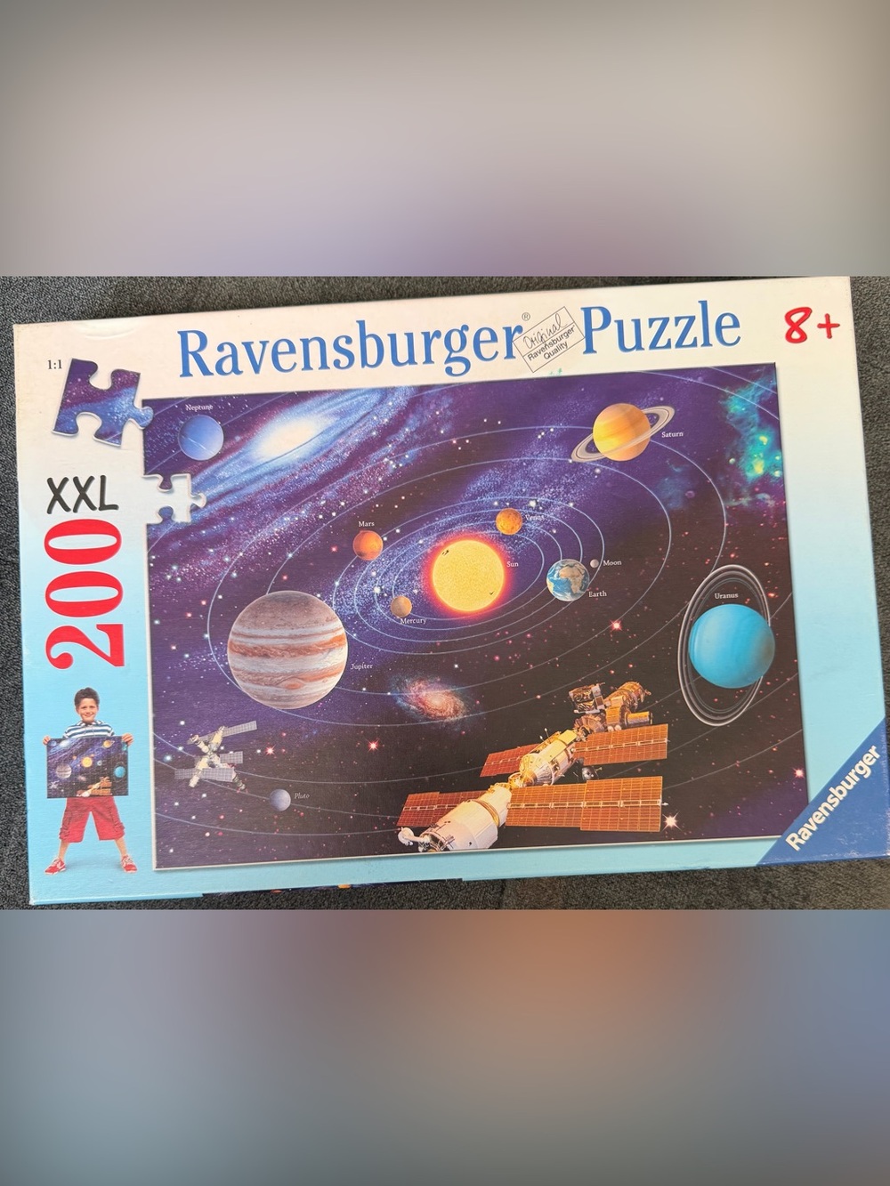Ravensburger Space Solar System Puzzle with Purple Starfield and Yellow Sun